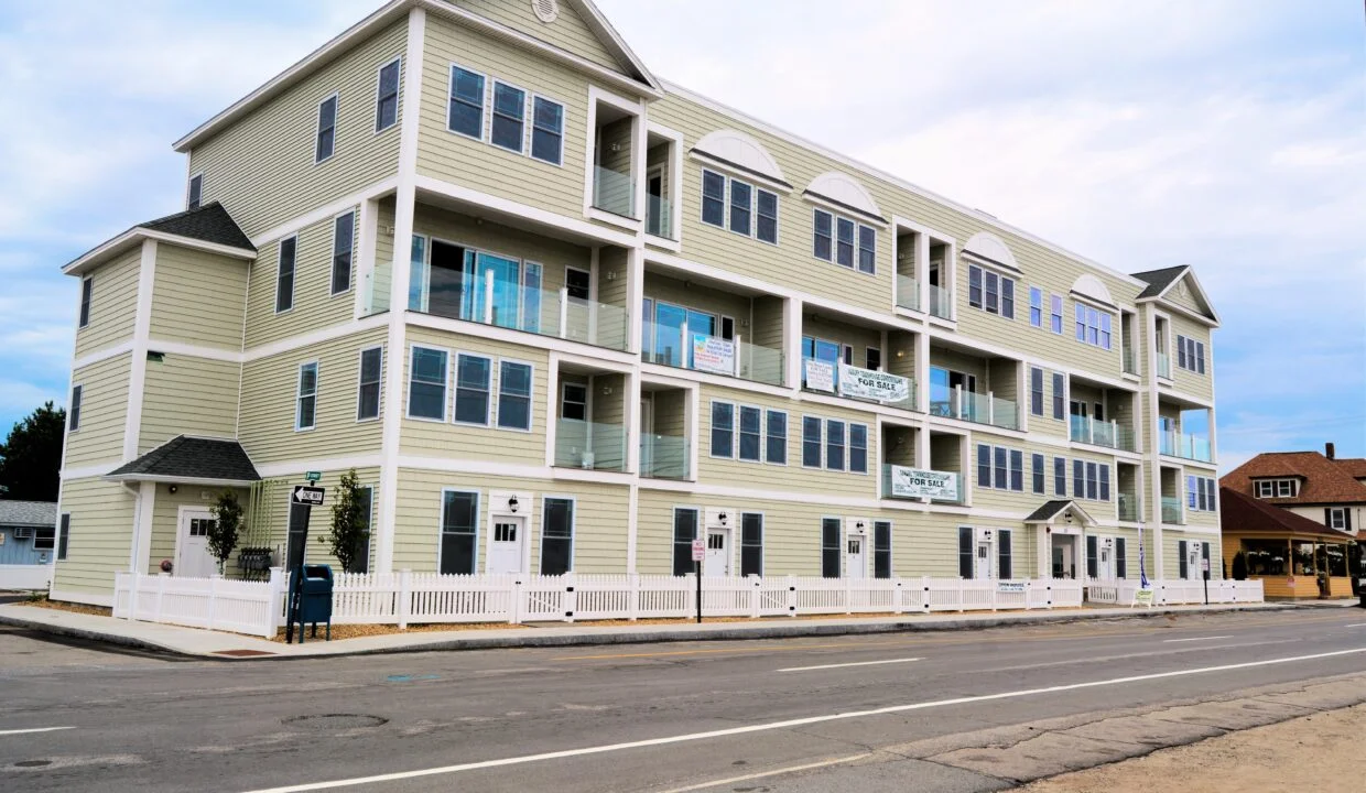 a two story apartment building on the side of the road.