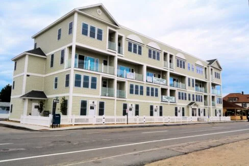 a two story apartment building on the side of the road.