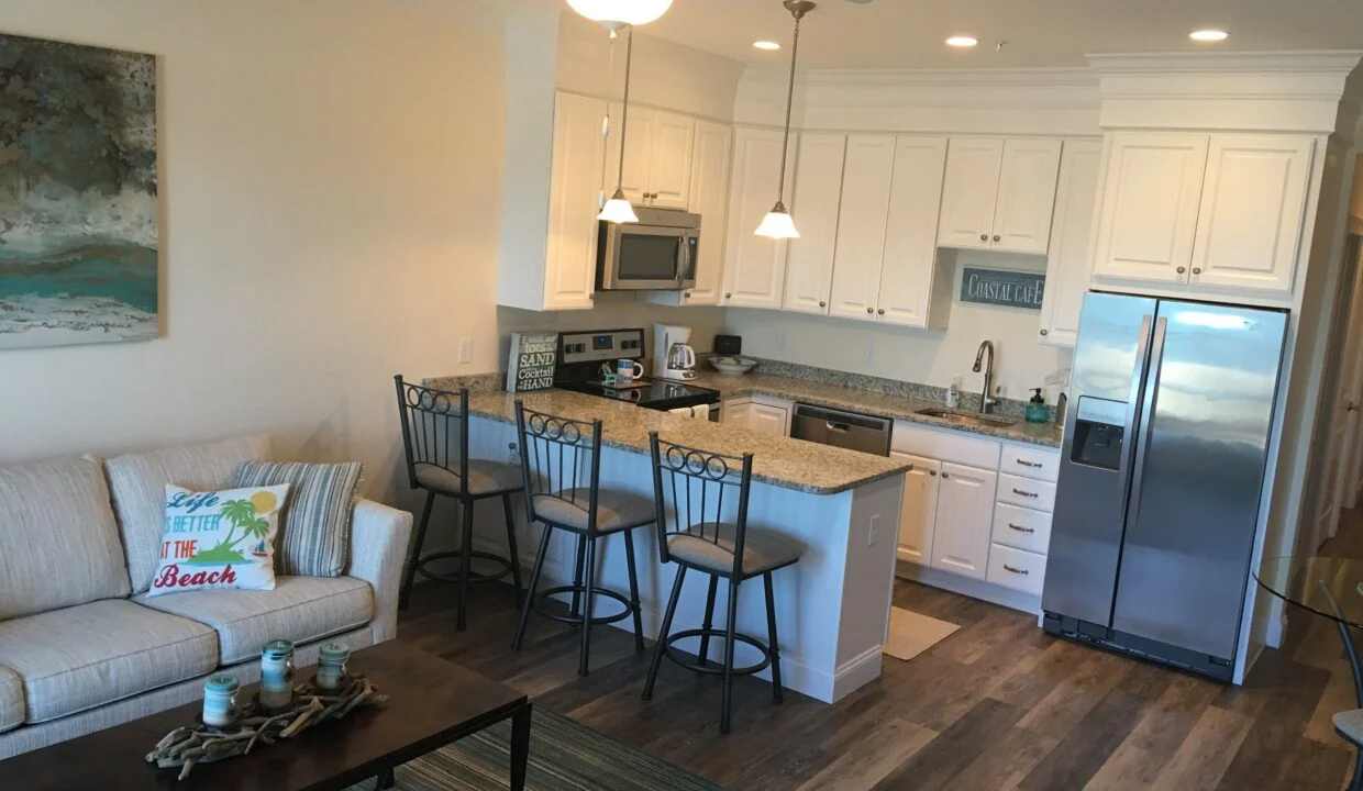 a living room with a couch a table and a refrigerator.