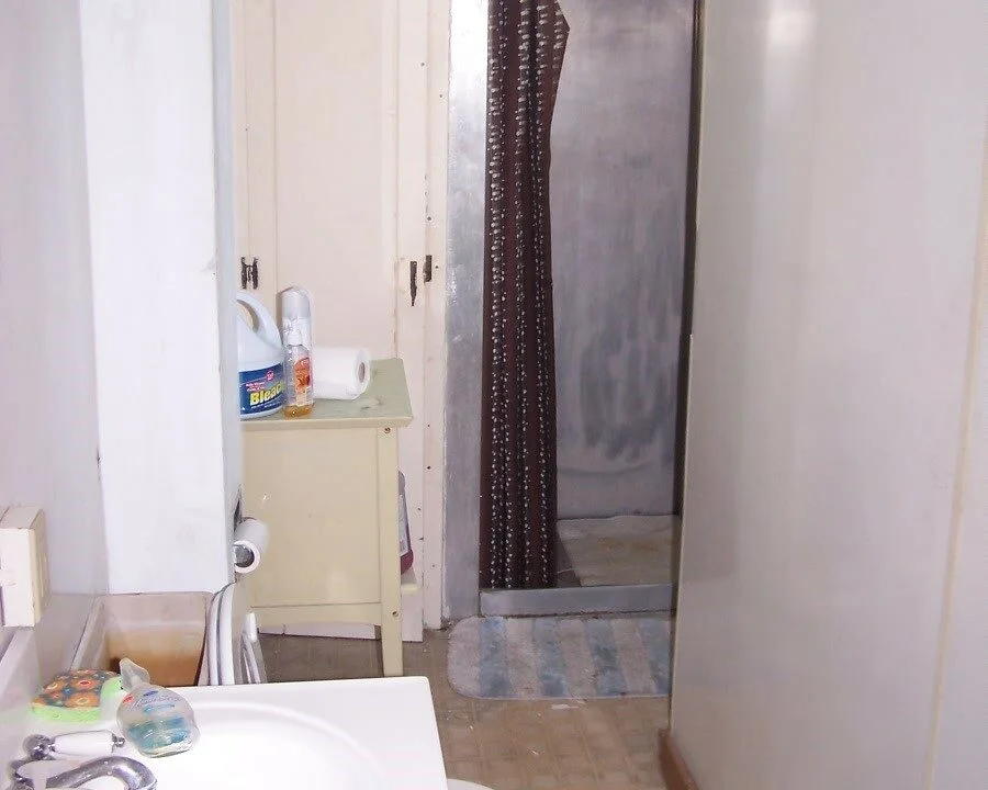 a bathroom with a sink and a shower.