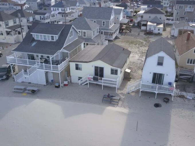 an aerial view of houses on a beach.