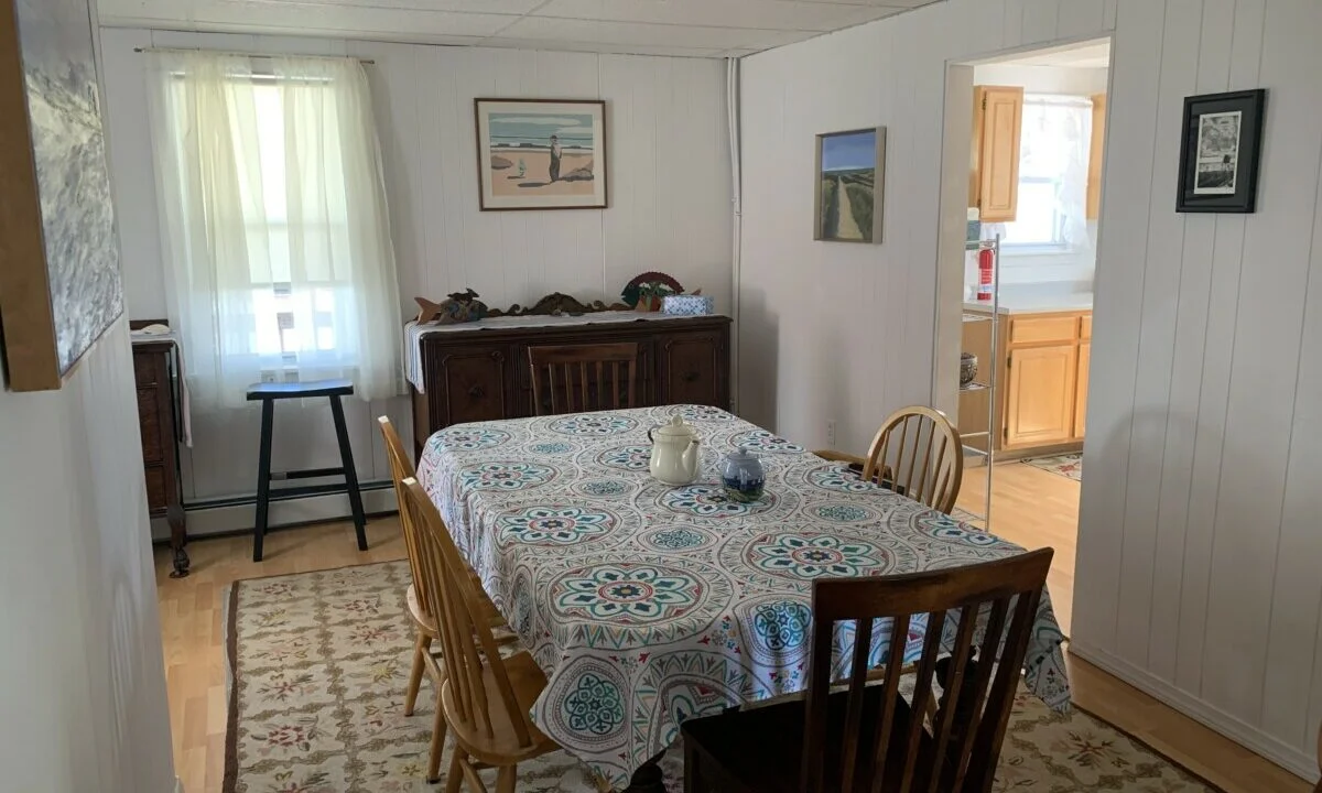 a dining room with a table and chairs.