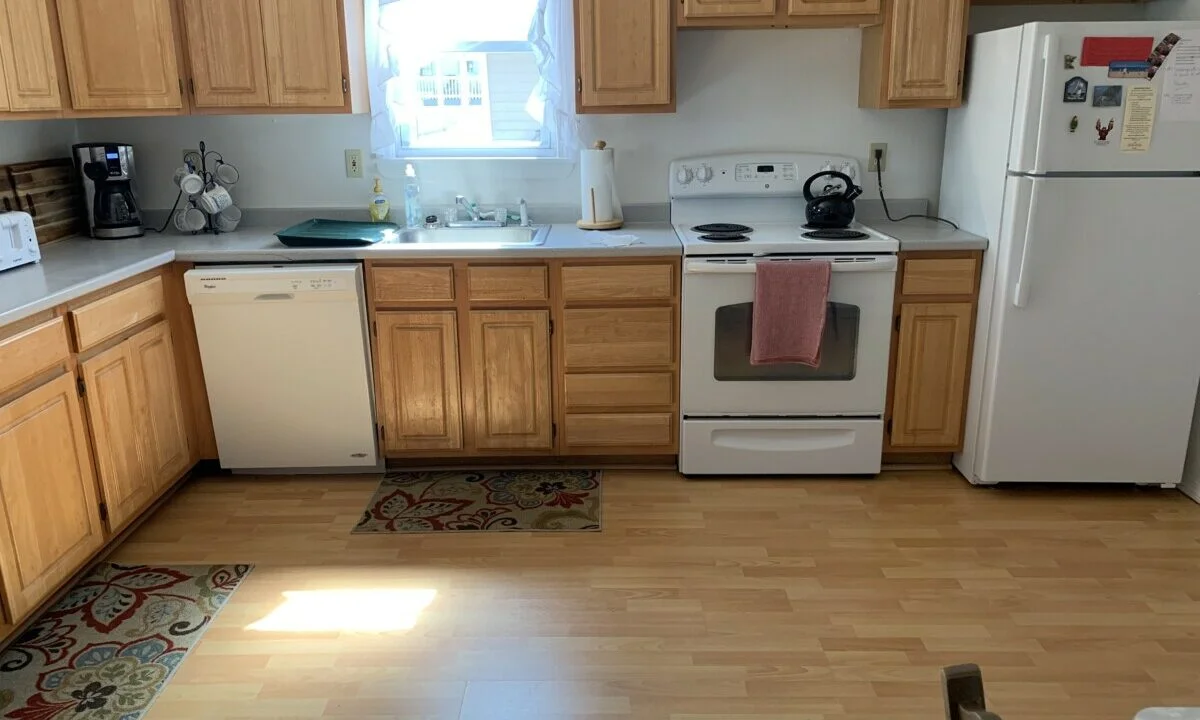 a kitchen with wooden cabinets and white appliances.