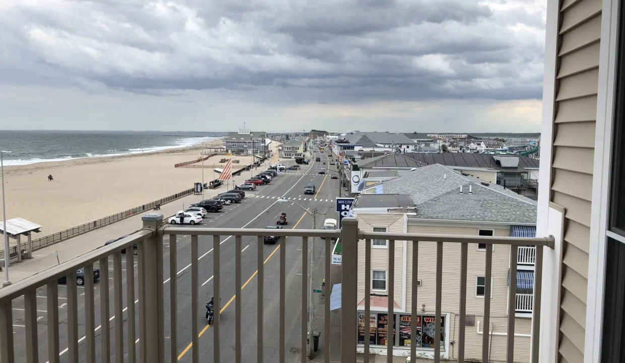 a balcony with a view of the beach and ocean.