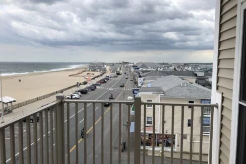 a balcony with a view of the beach and ocean.