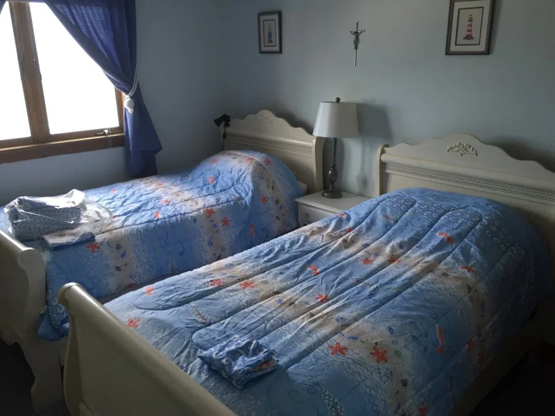 a couple of beds sitting next to each other in a bedroom.