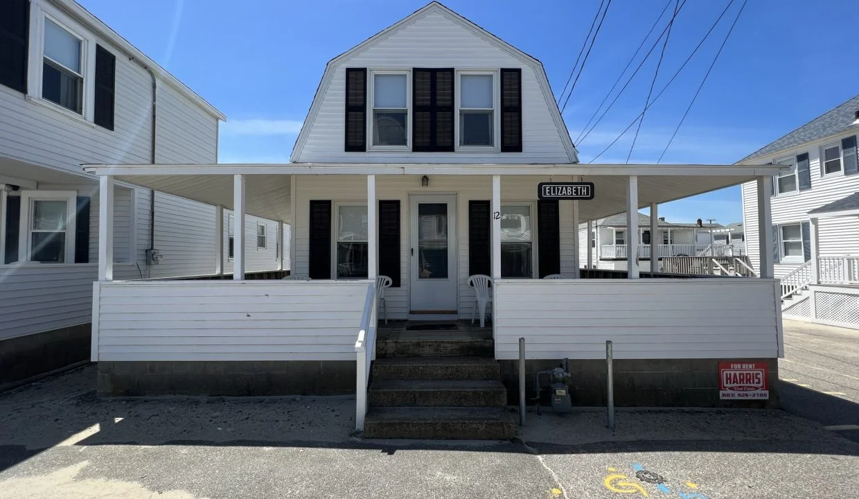 a white two story house with black shutters.