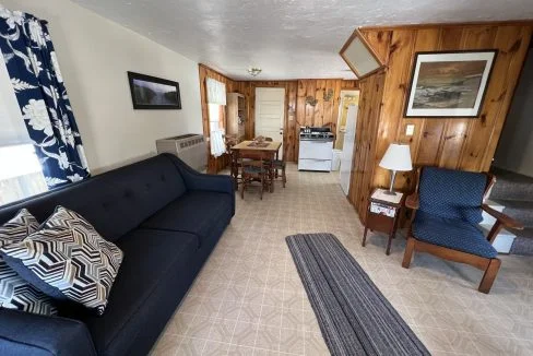 a living room filled with furniture and a blue couch.