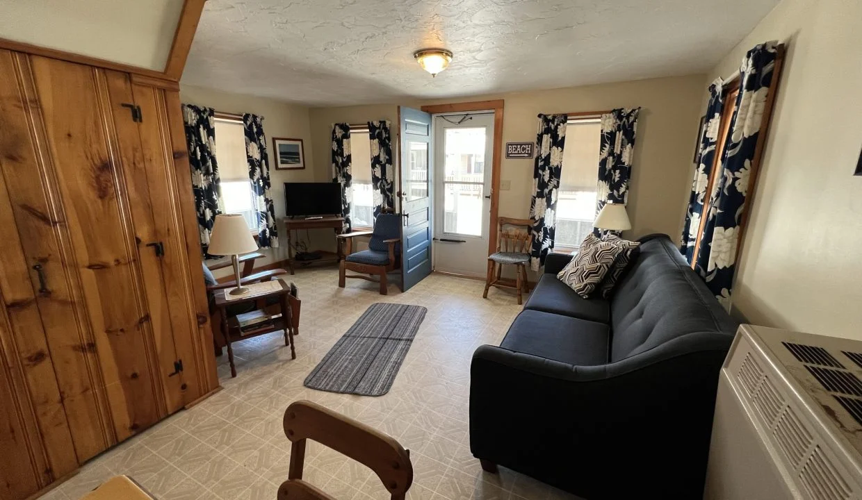 a living room filled with furniture and a flat screen tv.