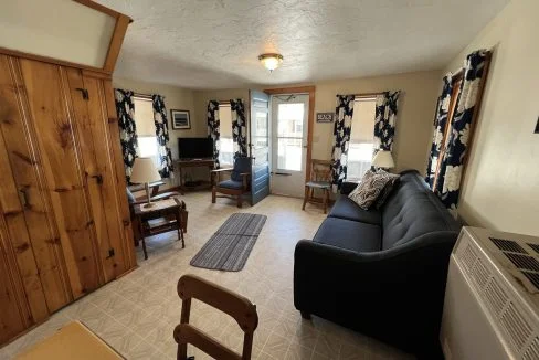 a living room filled with furniture and a flat screen tv.