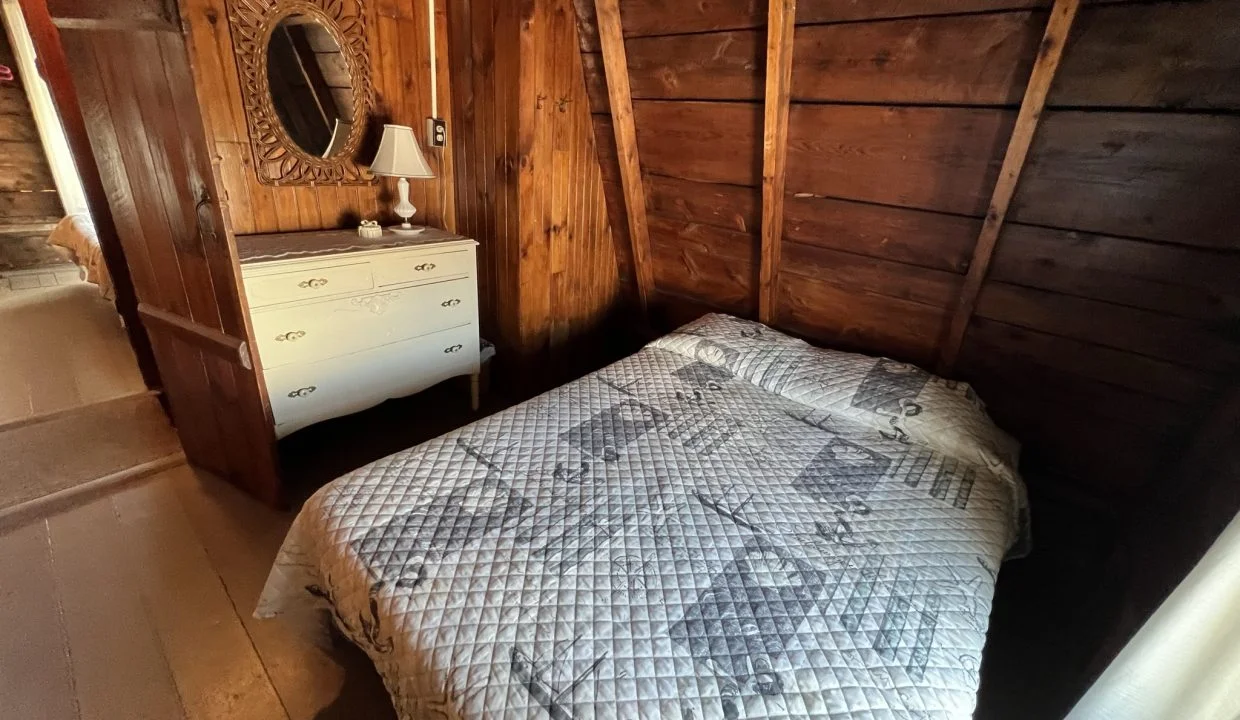 a bed sitting in a bedroom next to a dresser.