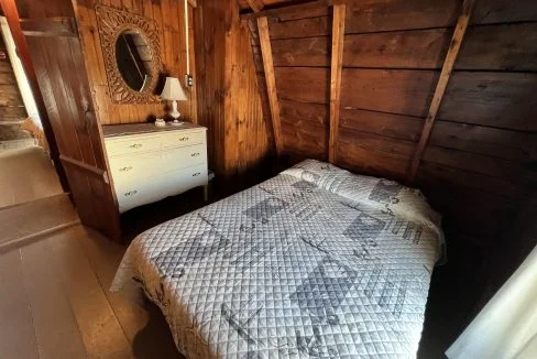 a bed sitting in a bedroom next to a dresser.