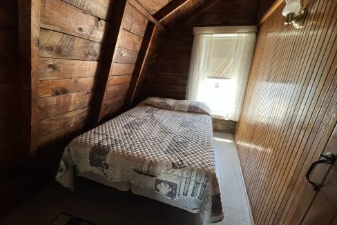 a bed sitting in a bedroom next to a window.