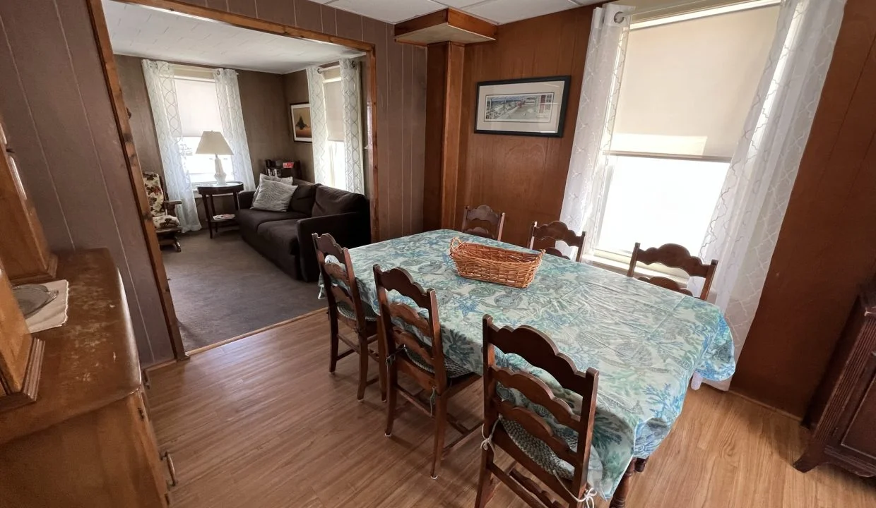 a dining room table with a basket on top of it.