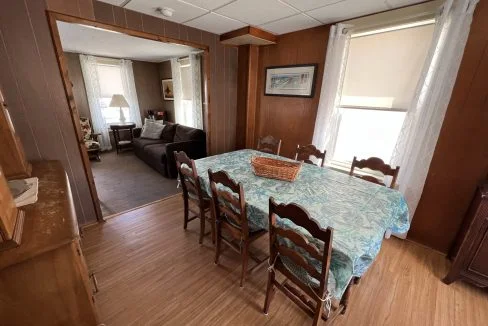 a dining room table with a basket on top of it.