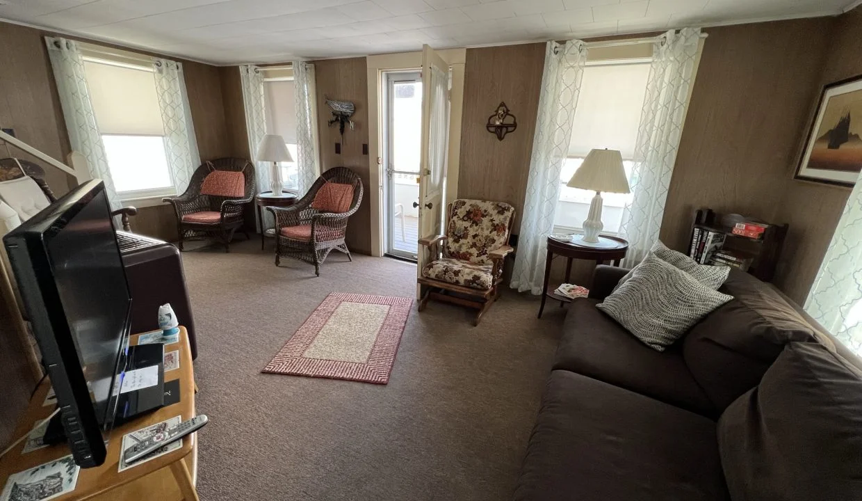 a living room filled with furniture and a flat screen tv.