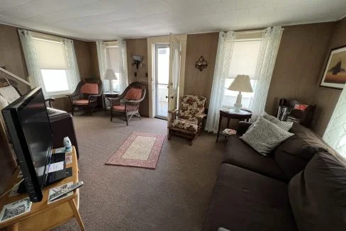 a living room filled with furniture and a flat screen tv.