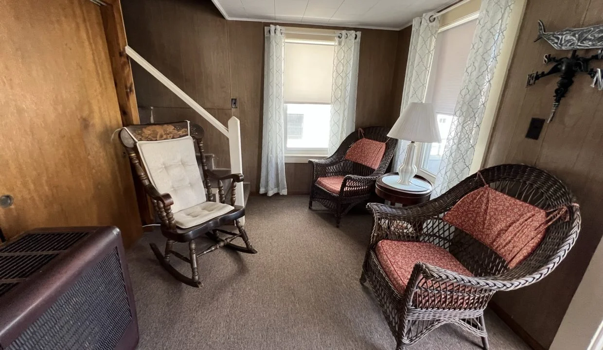 a living room filled with furniture and a flat screen tv.