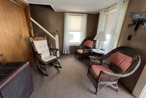 a living room filled with furniture and a flat screen tv.