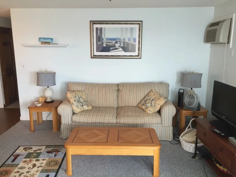 a living room filled with furniture and a flat screen tv.