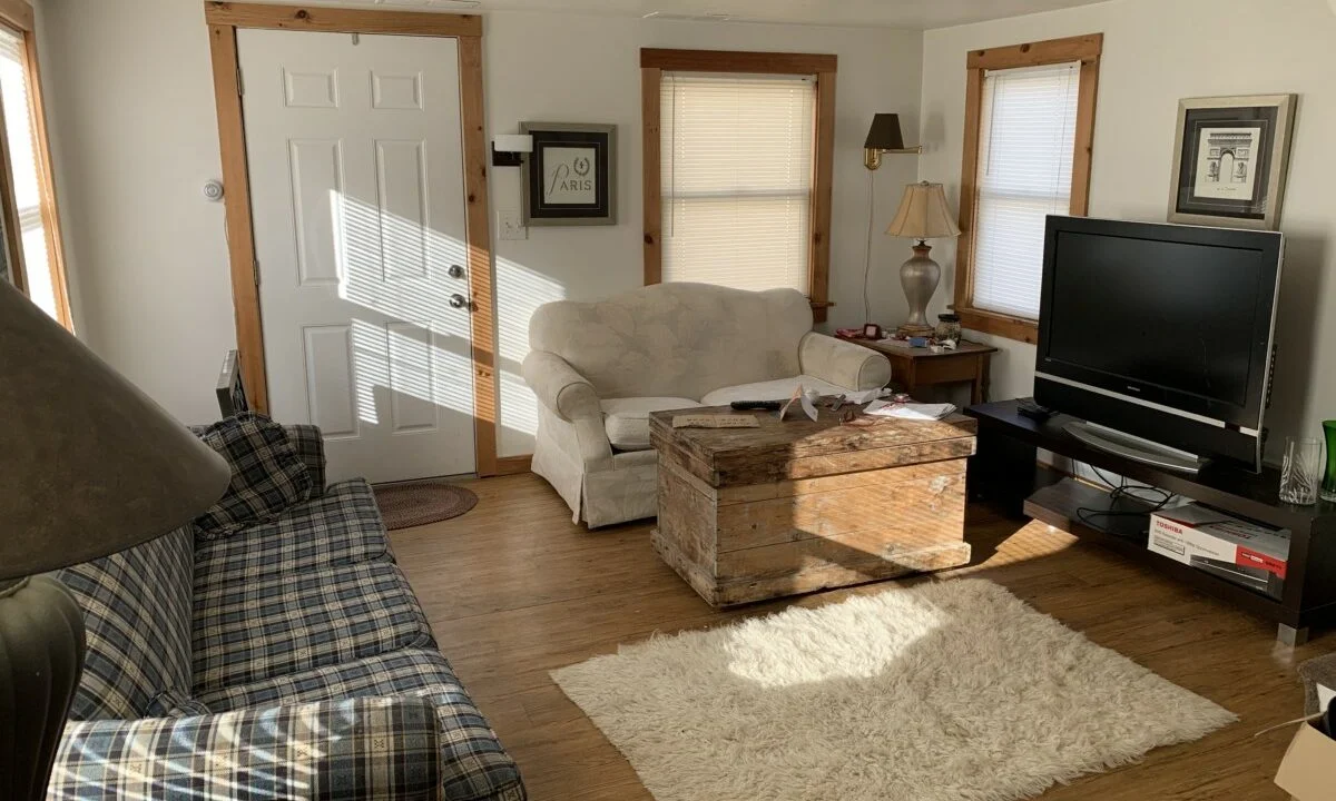 a living room filled with furniture and a flat screen tv.