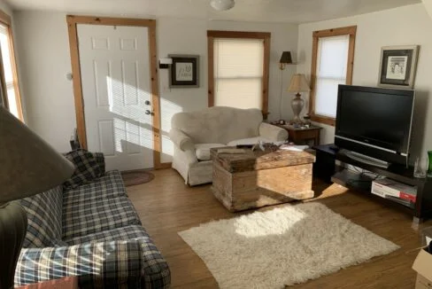 a living room filled with furniture and a flat screen tv.