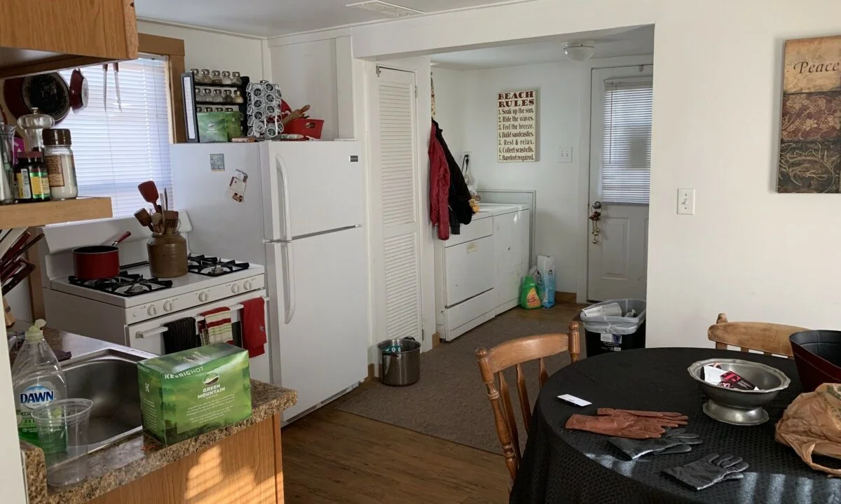 a kitchen with a table and a refrigerator.