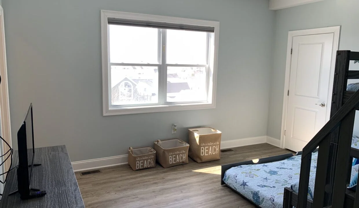 a bedroom with a bed and a tv in it.