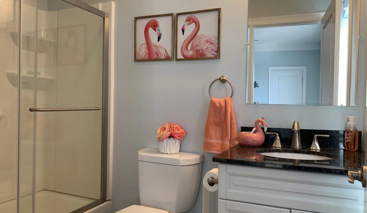 a bathroom with a sink, toilet, and shower.