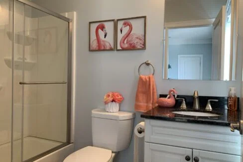 a bathroom with a sink, toilet, and shower.