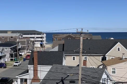 a view of the ocean from a rooftop of a house.