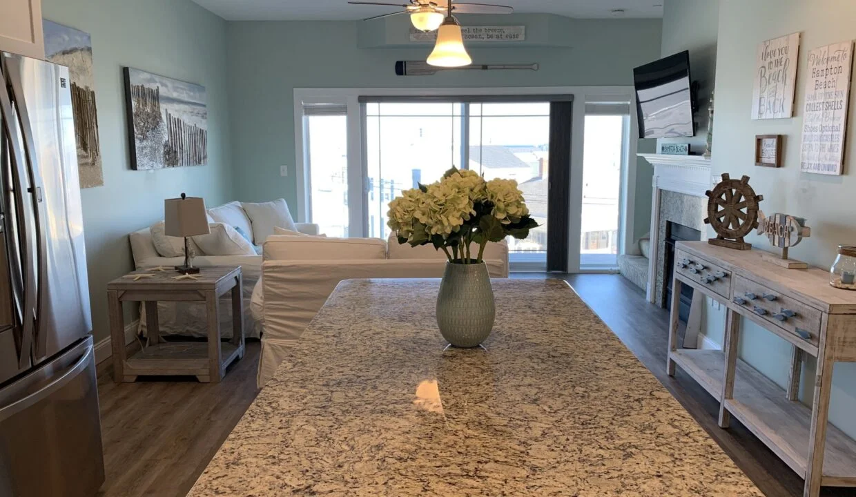 a vase of flowers sitting on top of a kitchen counter.