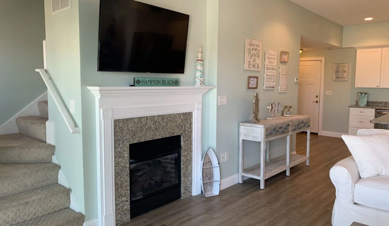 a living room filled with furniture and a flat screen tv.