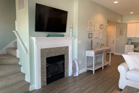 a living room filled with furniture and a flat screen tv.