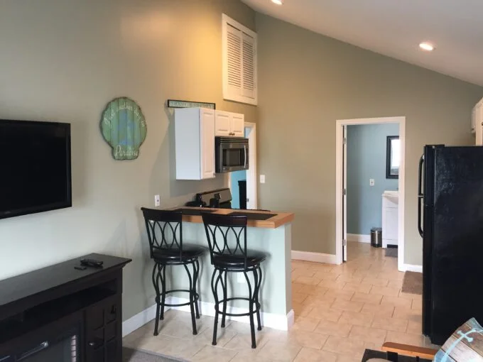 a kitchen with a black refrigerator freezer sitting next to a counter.