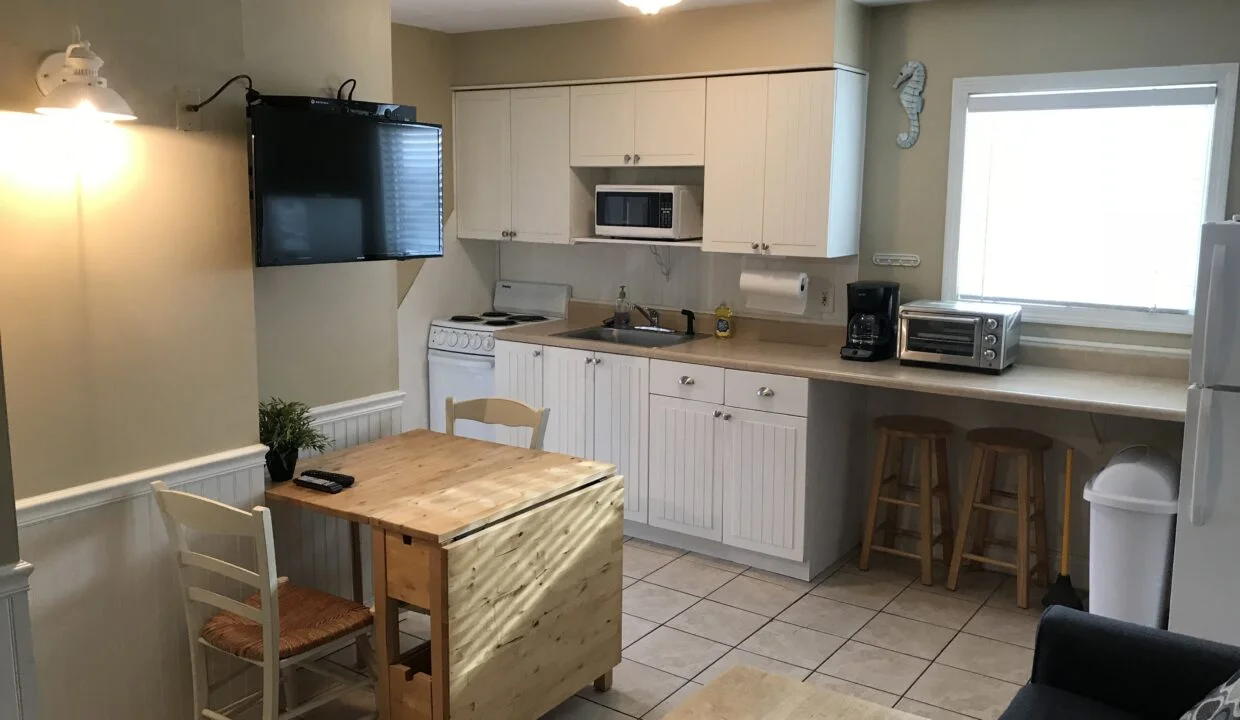 a kitchen with a table and a microwave.