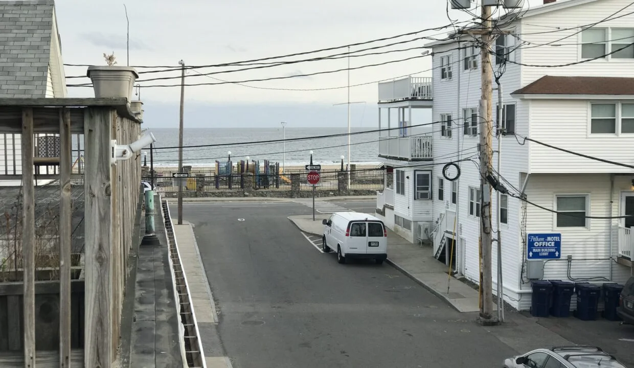 a white van parked on the side of a road.