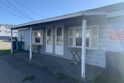 a small white building with a sign on the front of it.