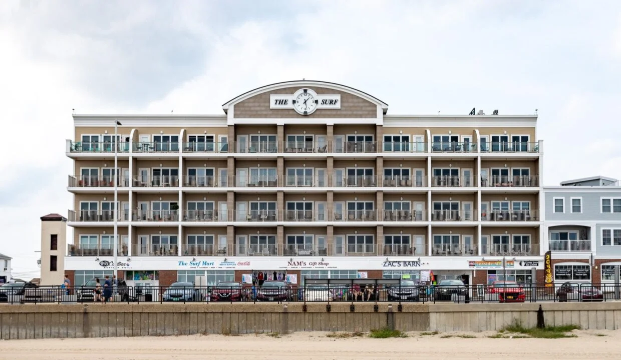 a large building sitting on top of a sandy beach.