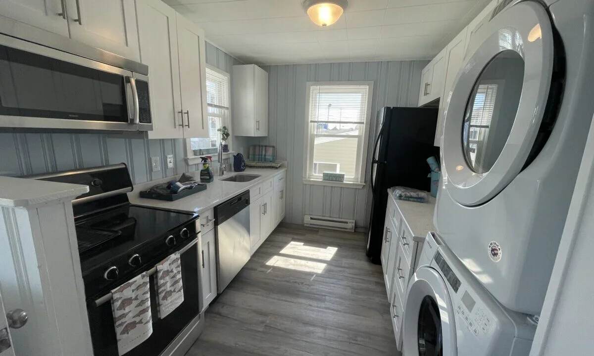 a kitchen with a washer and dryer in it.