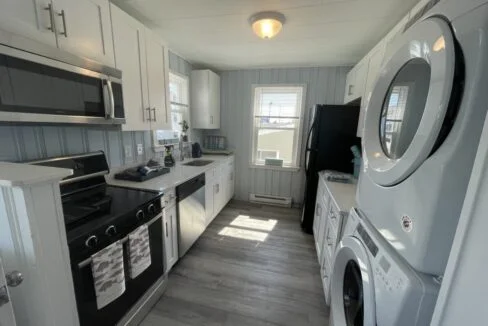 a kitchen with a washer and dryer in it.