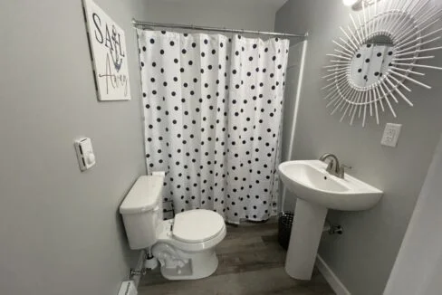 a white toilet sitting next to a sink in a bathroom.