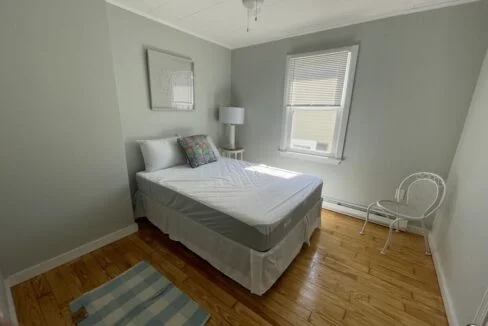 a bed sitting in a bedroom next to a window.