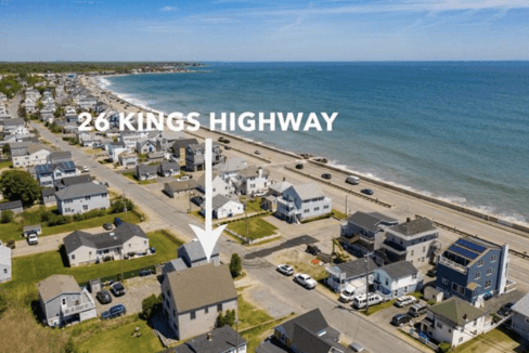 Aerial view of a coastal town with an arrow pointing to a house labeled 