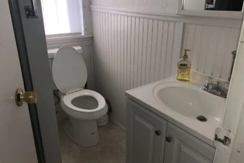 a white toilet sitting next to a white sink.