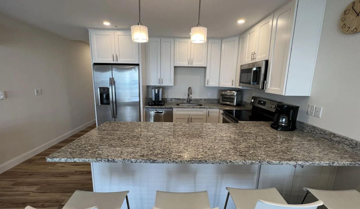 a kitchen with a center island with four chairs.