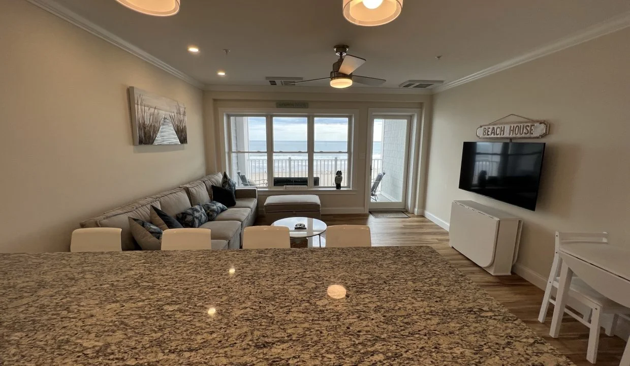 a living room with a couch a table and a tv.