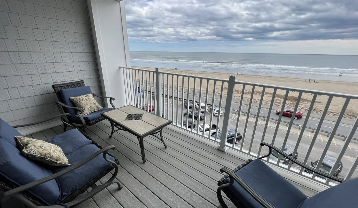 a couple of chairs sitting on top of a wooden deck.