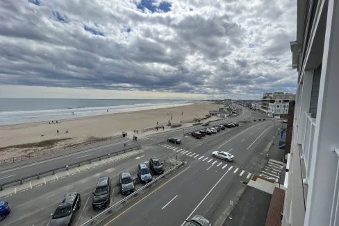 a view of a beach from a balcony of a building.