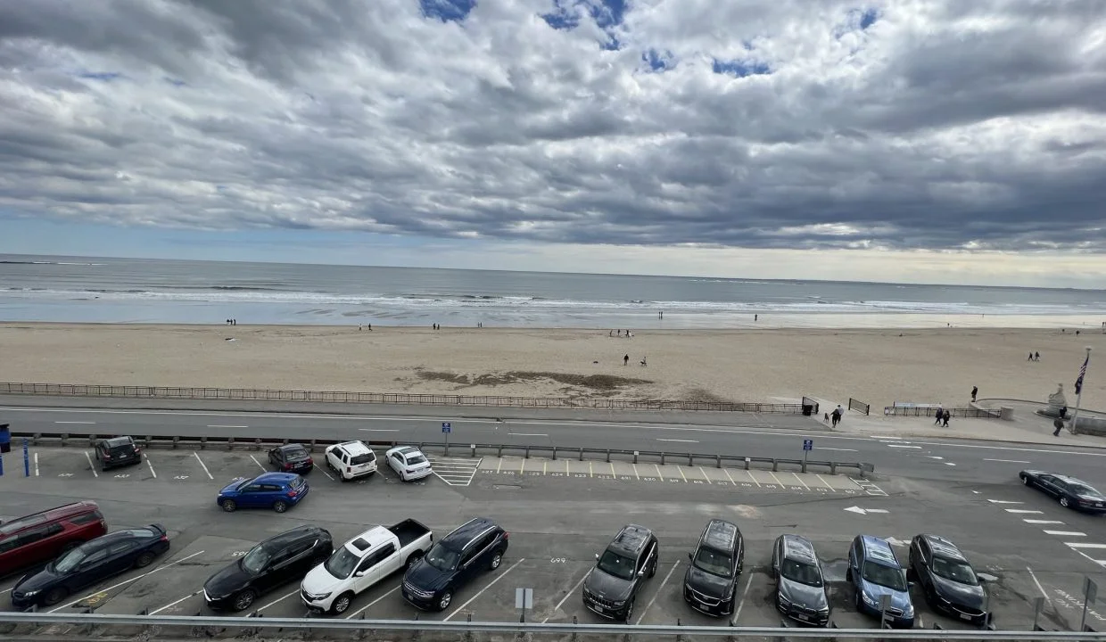 a parking lot filled with lots of parked cars.